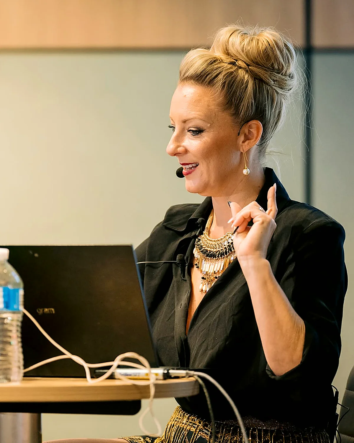 Sarah Cordiner at her laptop with a headset, explaining something on screen