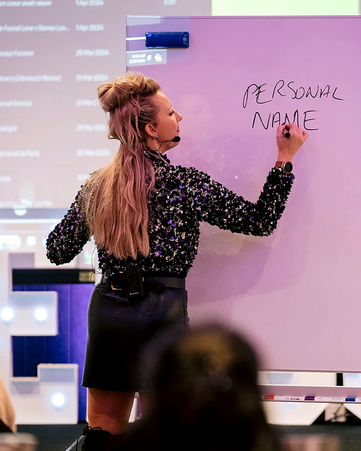 Sarah Cordiner writing on a whiteboard during a personal branding workshop